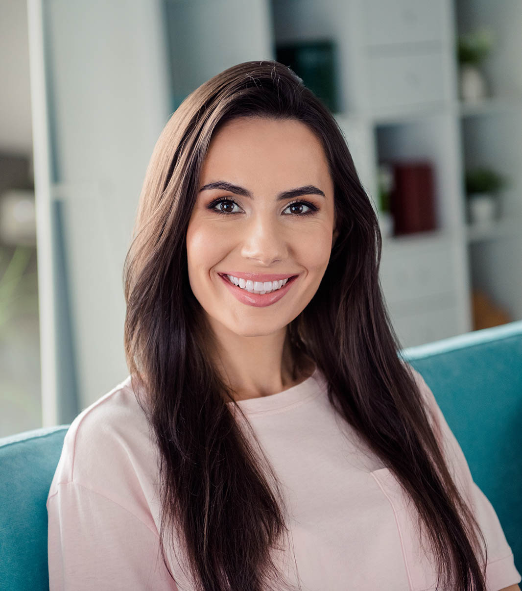 Portrait of adorable satisfied glad young girl sitting comfy sofa good mood weekend day house inside Pay0